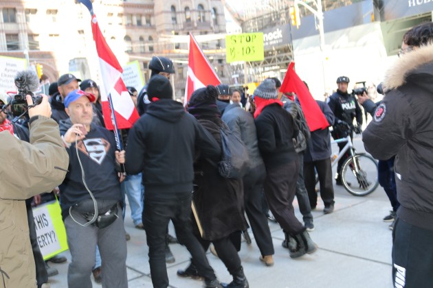 M103 protest in Toronto -Some supporters of M103 formed a human chain to halt the advancement of those against M103 - Photo Mosaic Edition Edward Akinwunmi