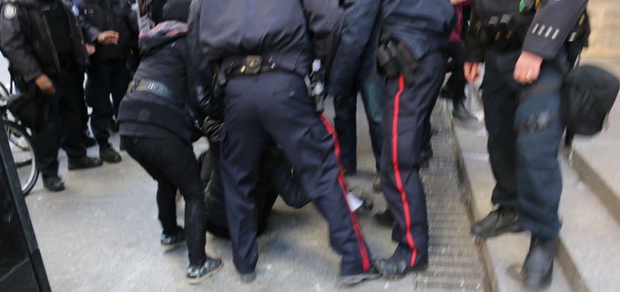 M103 protest in Toronto - Police tackle a protester - Photo Mosaic Edition Edward Akinwunmi