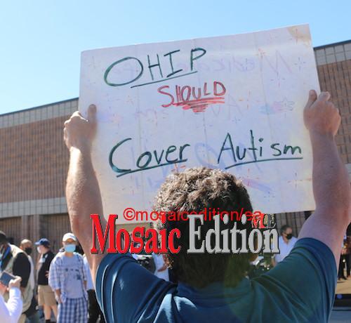 Protester at O'Toole event in Markham - OHIP should cover Autism. Photo Mosaic Edition Edward Akinwunmi