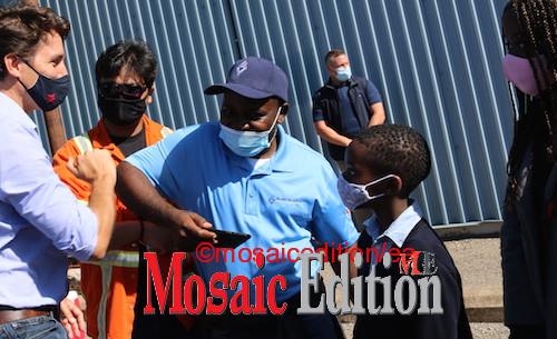Justin Trudeau bumps elbow in pandemic greeting with a worker at Valbruna ASW INC. The worker was at the event with his children. Pandemic greeting. Photo Mosaic Edition Edward Akinwunmi