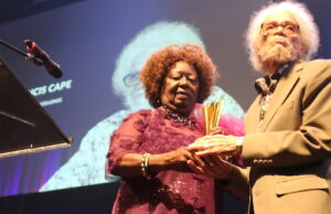 Jean Augustine presents the CTFF inaugural Augustine Award of Excellence to Roy Cape shortly after the screening of the documentary Iconography - Photo Mosaic Edition Edward Akinwunmi